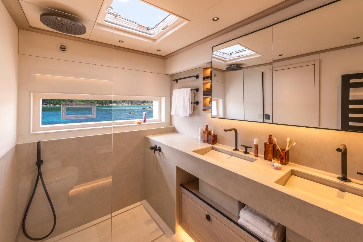 Ensuite bathroom of the Lagoon Eighty 2 with a walk-in shower, stone surfaces and a sea-view window